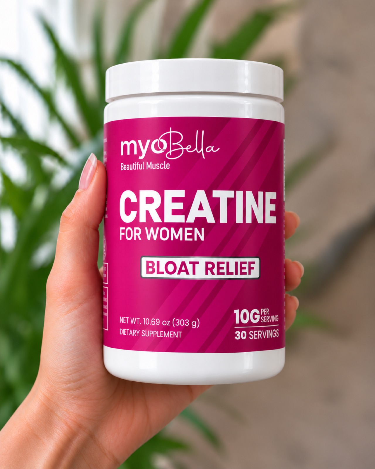 A hand holding a jar of MyoBella Creatine for Women